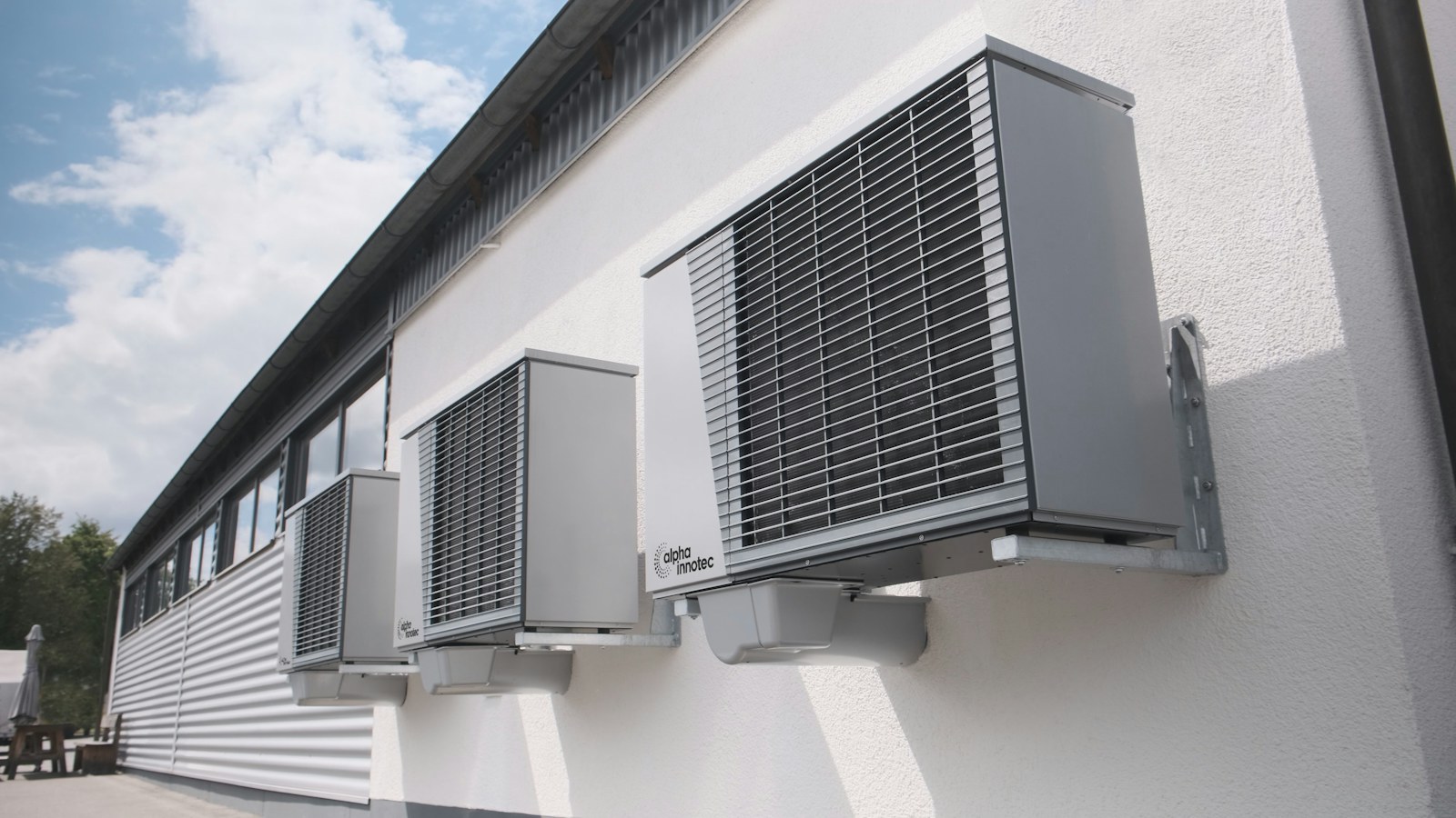 Wall-mounted residential heat-pump equipment on the exterior of a home.