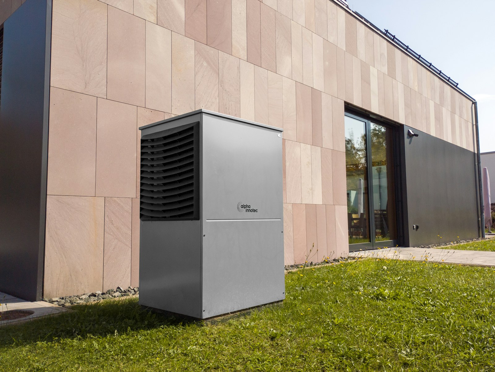 Outdoor residential heat-pump equipment beside a home.
